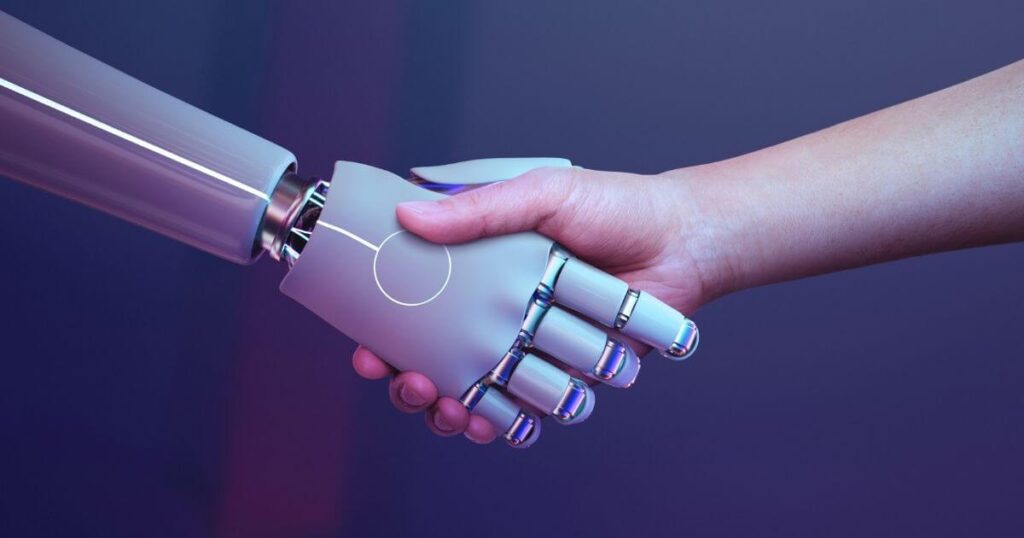 Una mano humana y una mano de un robot estrechándose en un saludo